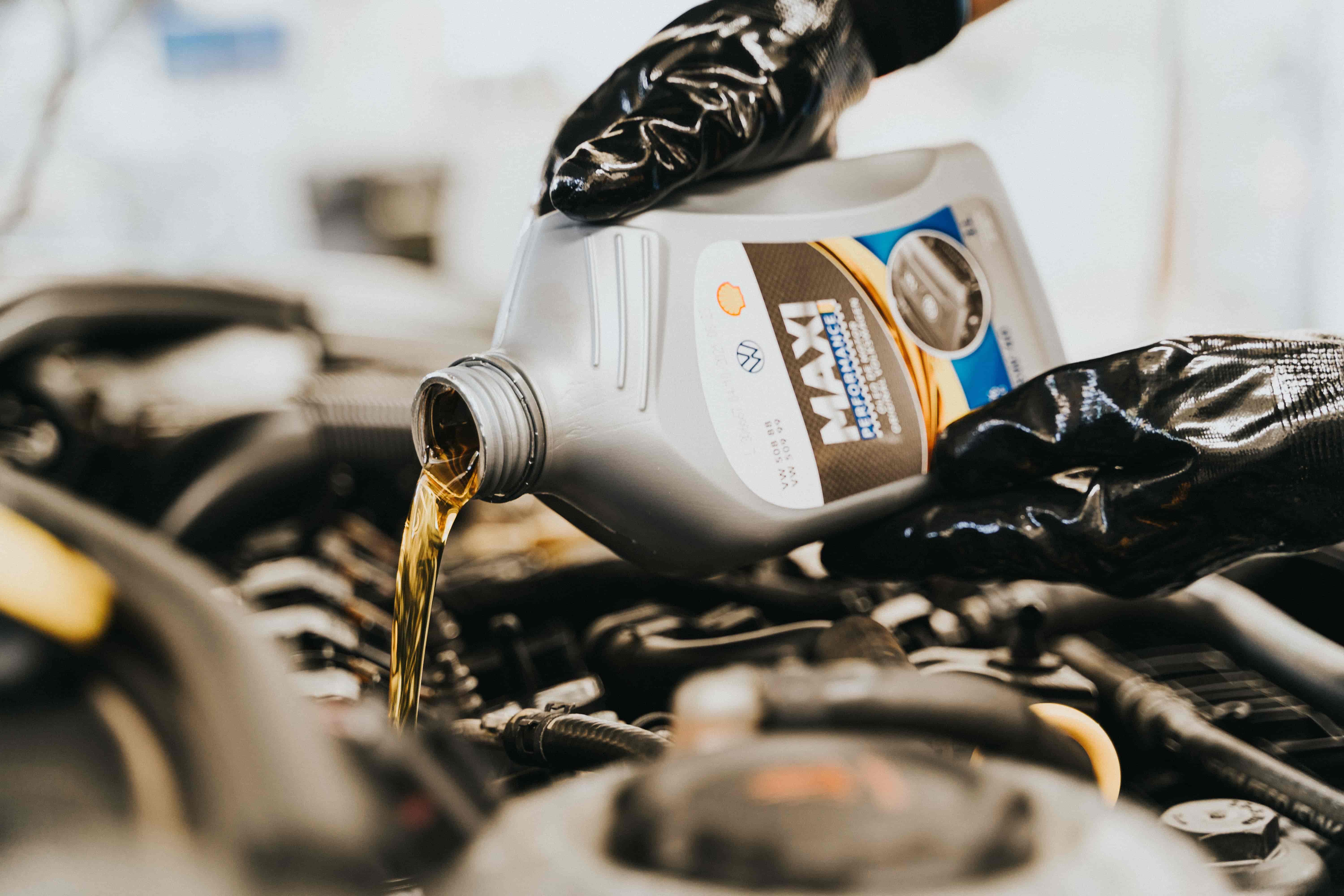 Fresh oil being poured into an engine during an oil change